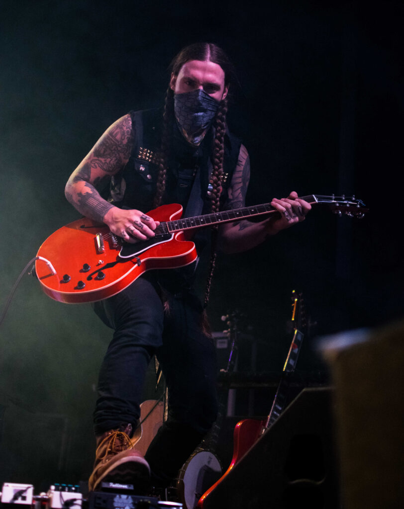 A man playing the electric guitar