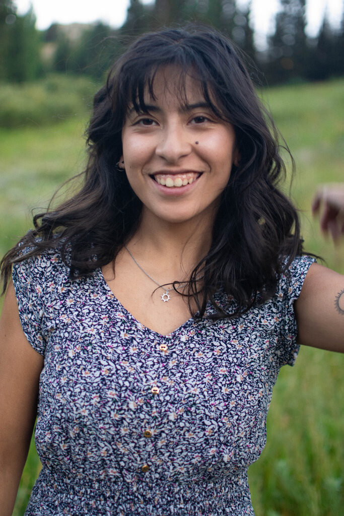 A woman smiling in a field