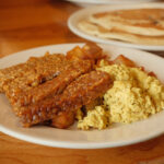 Tofu scramble, tempeh bacun, potatoes, and pancakes from Vertical Diner