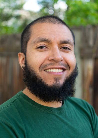 Man standing in front of fence